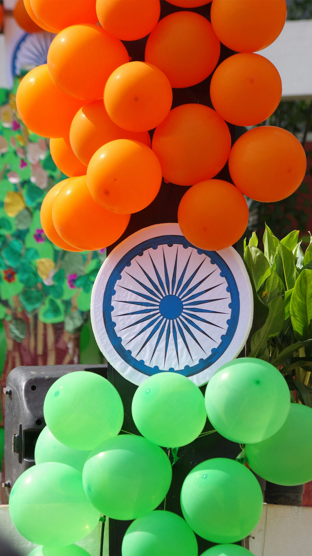 orange and green balloons with sudarshan chakra in the middle ok it